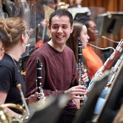 Clarinet players chat during a rehearsal